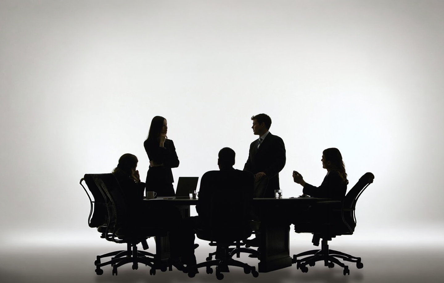 A team discussing commercial real estate around a meeting table
